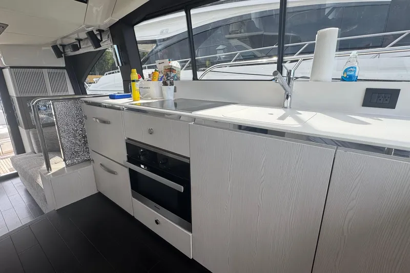 Slide: The Image of Modern kitchen interior of 2021 Azimut 50 Flybridge yacht with sleek cabinetry and appliances. - 22