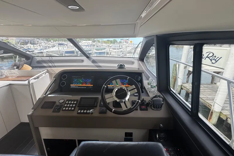 Slide: The Image of Interior helm of 2021 Azimut 50 Flybridge yacht with modern controls and marina view. - 25