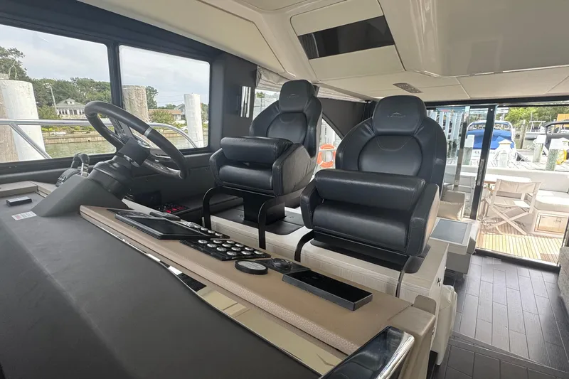 Slide: The Image of Interior of 2021 Azimut 50 Flybridge yacht with modern helm and seating. - 27