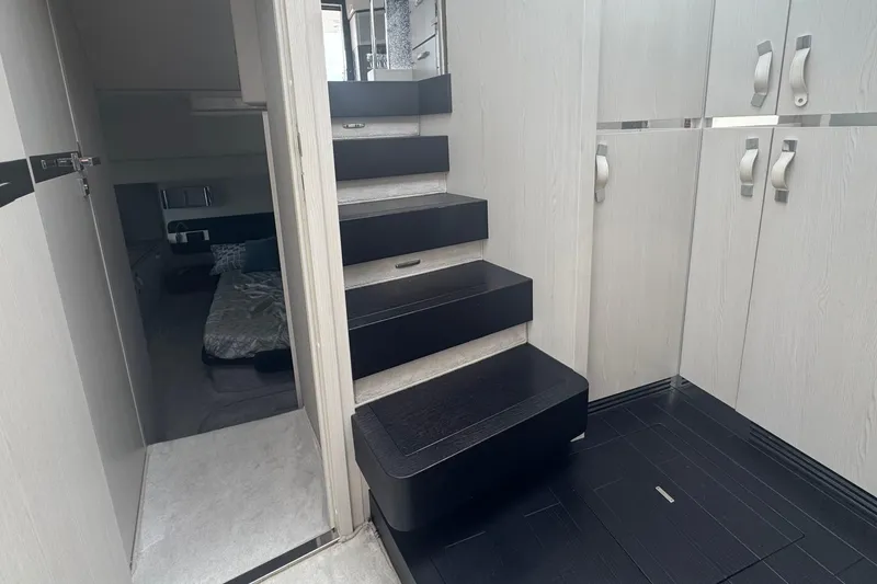 Slide: The Image of Interior of 2021 Azimut 50 Flybridge yacht with modern staircase and cabin view. - 29