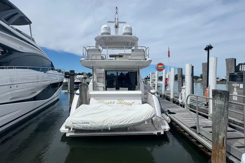 Slide: The Image of Azimut 50 Flybridge 2021 yacht docked at marina with covered tender. - 3