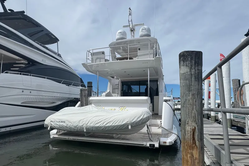 Slide: The Image of 2021 Azimut 50 Flybridge yacht docked with covered tender at marina. - 4