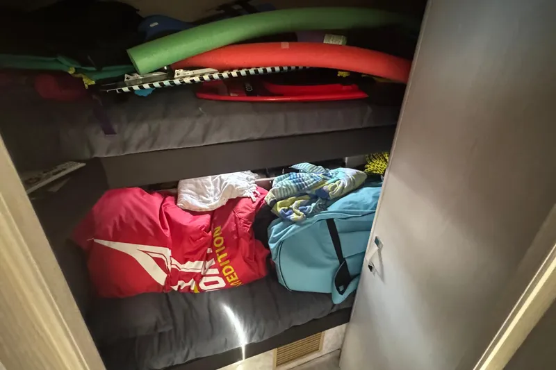 Slide: The Image of Interior of 2021 Azimut 50 Flybridge with bunk beds and stored items. - 41