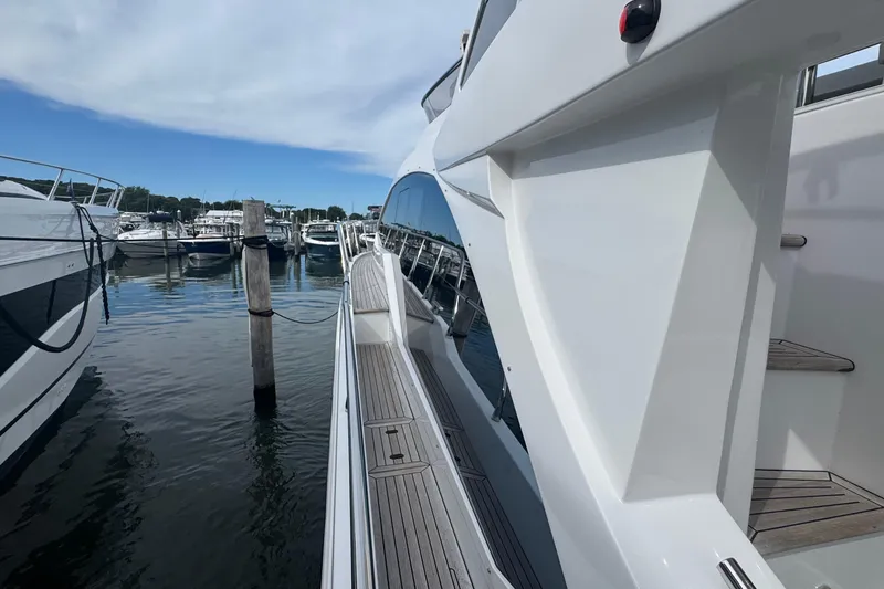 Slide: The Image of 2021 Azimut 50 Flybridge yacht docked at a marina, showcasing sleek design and modern features. - 43