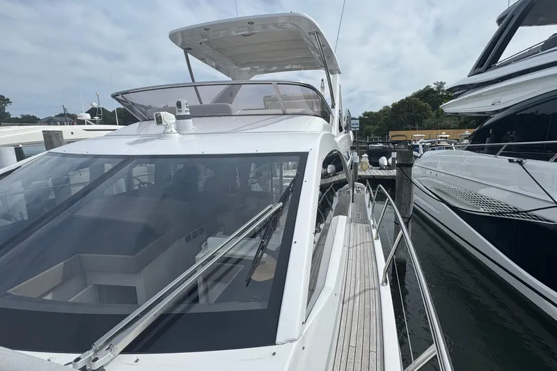 Slide: The Image of 2021 Azimut 50 Flybridge yacht docked at marina, showcasing sleek design and spacious flybridge. - 45