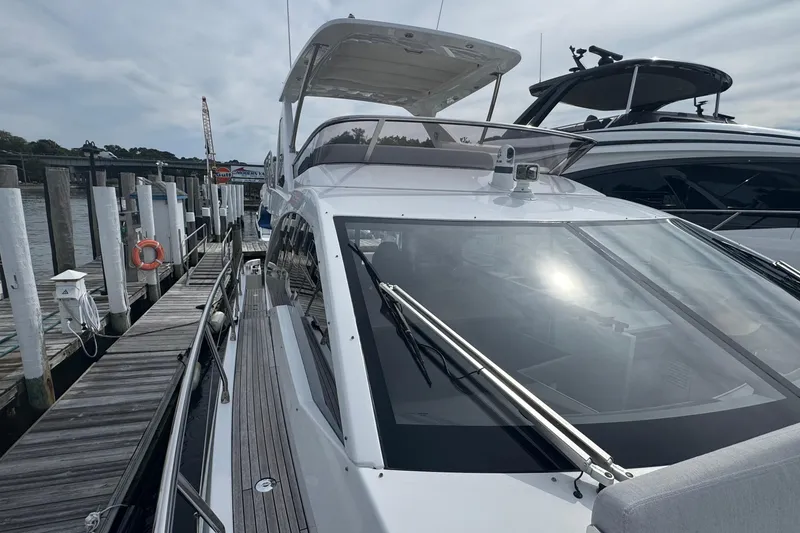 Slide: The Image of 2021 Azimut 50 Flybridge yacht docked at a marina, showcasing sleek design and modern features. - 48