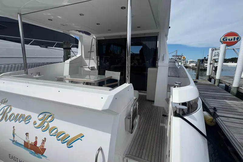 Slide: The Image of Azimut 50 Flybridge 2021 yacht docked at marina, featuring elegant design and spacious deck. - 5