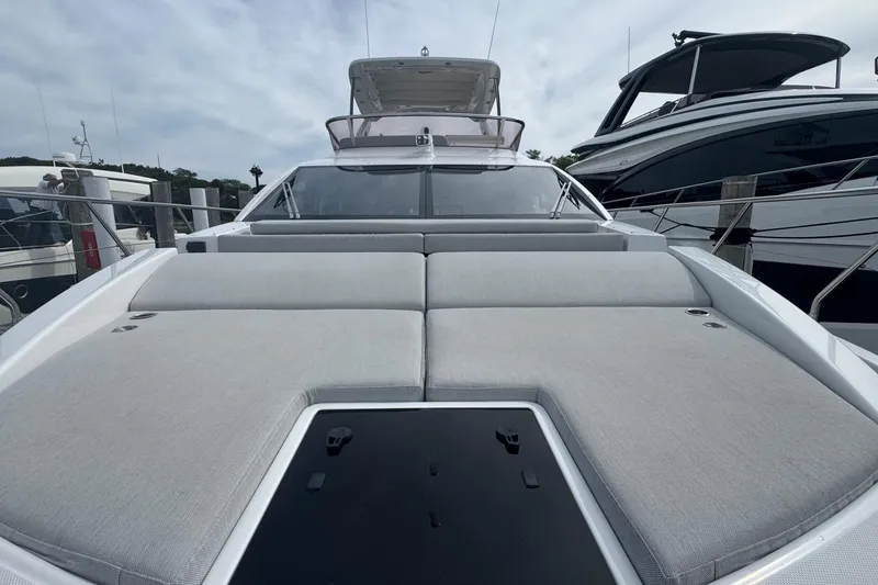 Slide: The Image of 2021 Azimut 50 Flybridge yacht with spacious sunbathing area, docked at marina. - 51
