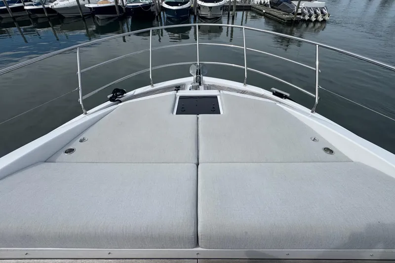 Slide: The Image of Bow view of 2021 Azimut 50 Flybridge yacht with cushioned sunbathing area. - 53