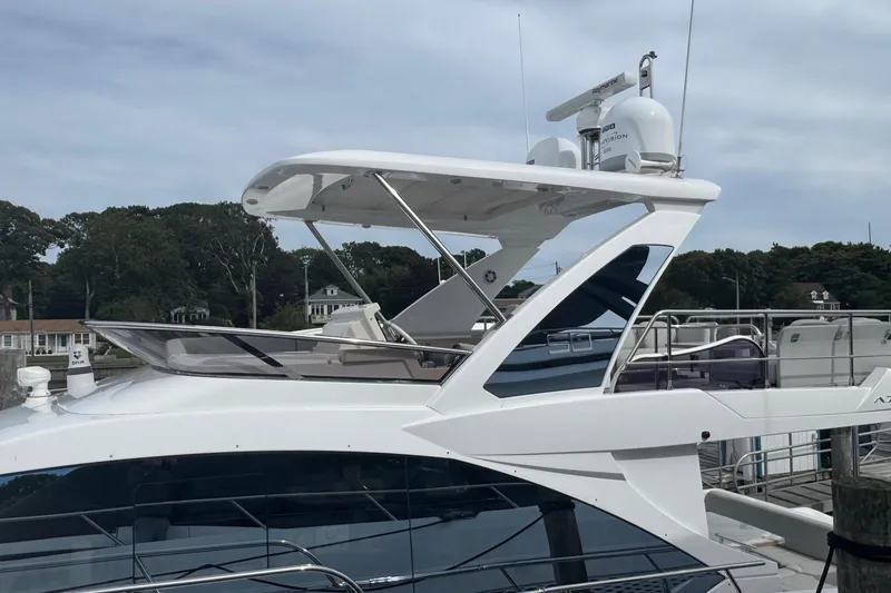 Slide: The Image of 2021 Azimut 50 Flybridge yacht docked, showcasing sleek design and modern features. - 55