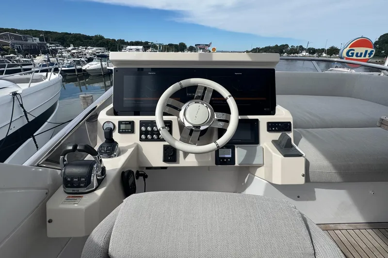 Slide: The Image of 2021 Azimut 50 Flybridge yacht helm with modern controls and navigation system. - 59
