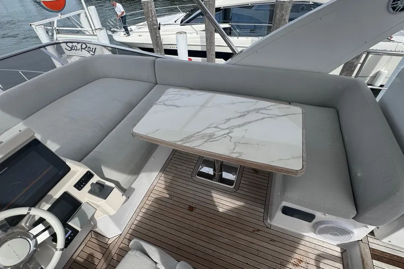 Slide: The Image of Luxurious 2021 Azimut 50 Flybridge yacht interior with marble table and plush seating. - 61