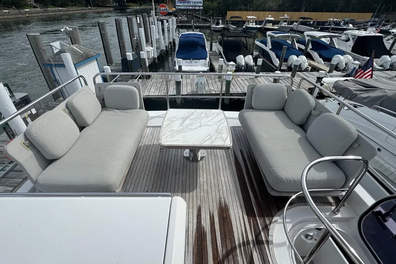 Slide: The Image of Luxurious seating area on 2021 Azimut 50 Flybridge yacht, docked at marina. - 63