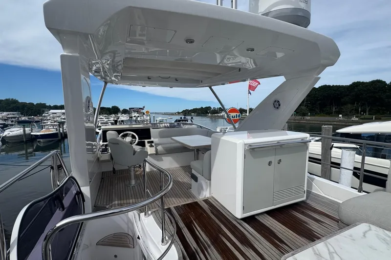 Slide: The Image of 2021 Azimut 50 Flybridge yacht with elegant deck and marina view. - 64