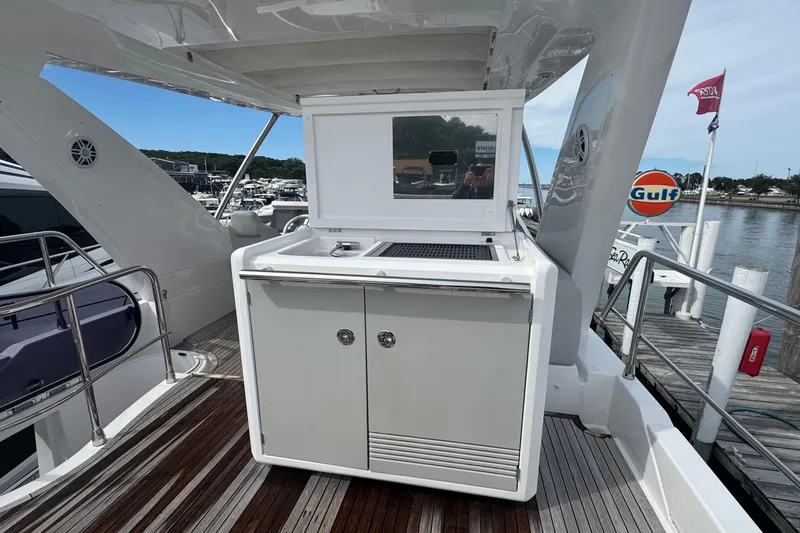 Slide: The Image of Azimut 50 Flybridge 2021 yacht with outdoor kitchen on deck, docked at marina. - 65