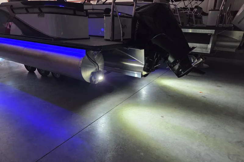 Slide: The Image of 2026 Avalon Platinum LSZ 2385 Quad Lounger pontoon boat with illuminated under-deck lighting. - 16