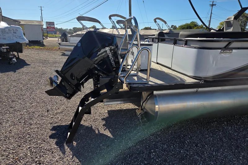 Slide: The Image of 2026 Avalon Platinum LSZ 2385 Quad Lounger with Mercury outboard motor on gravel lot. - 4