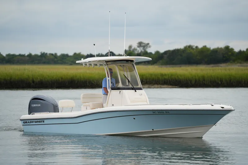 Slide: The Image of 2023 Grady-White 251 Coastal Explorer boat on calm water, with Yamaha engine. - 11