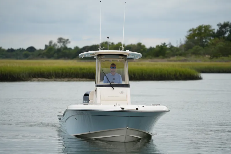 Slide: The Image of 2023 Grady-White 251 Coastal Explorer boat navigating calm waters. - 13