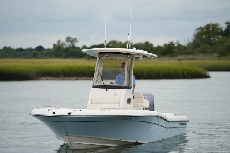Slide: The Image of 2023 Grady-White 251 Coastal Explorer boat cruising on calm water. - 16