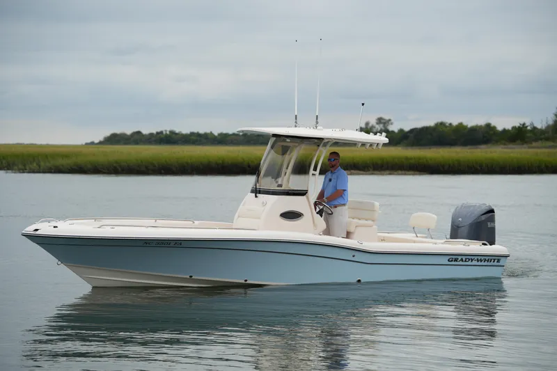 Slide: The Image of 2023 Grady-White 251 Coastal Explorer boat on calm water, side view. - 19