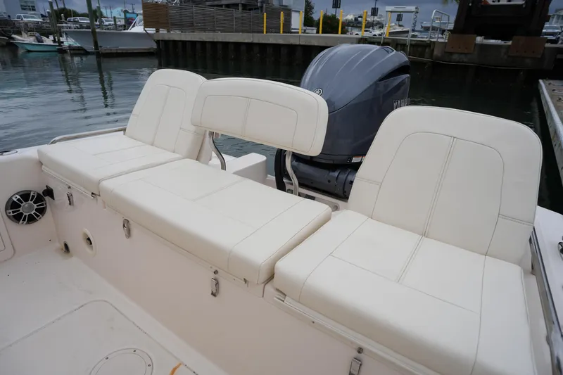 Slide: The Image of 2023 Grady-White 251 Coastal Explorer boat seating and engine view at dock. - 22