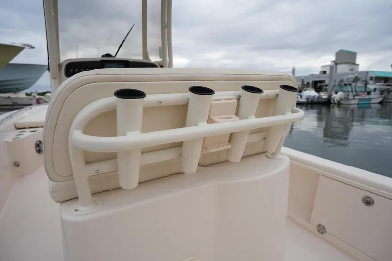 Slide: The Image of 2023 Grady-White 251 Coastal Explorer boat with rod holders, docked at marina. - 24