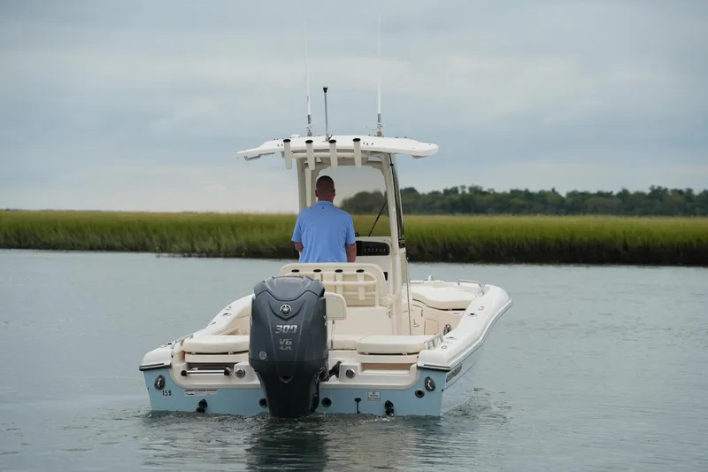 Slide: The Image of 2023 Grady-White 251 Coastal Explorer boat on calm water, rear view. - 3