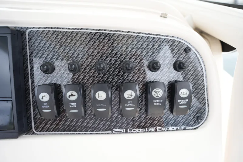 Slide: The Image of Control panel of 2023 Grady-White 251 Coastal Explorer boat with labeled switches. - 34