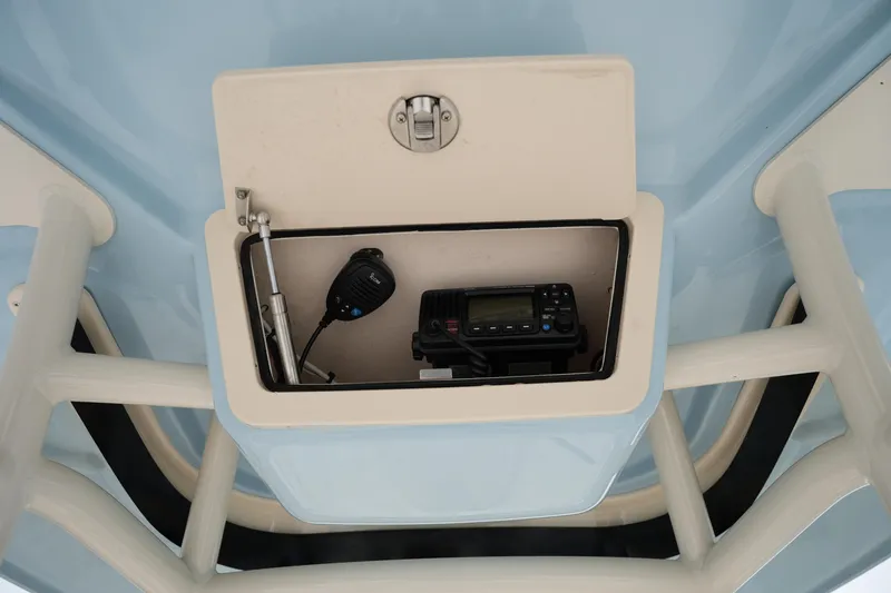 Slide: The Image of Storage compartment with radio equipment on 2023 Grady-White 251 Coastal Explorer boat. - 36