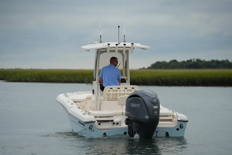 Slide: The Image of 2023 Grady-White 251 Coastal Explorer boat on calm water with Yamaha engine. - 4