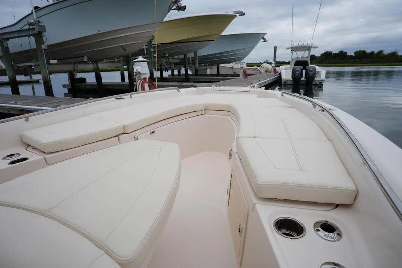 Slide: The Image of 2023 Grady-White 251 Coastal Explorer boat with spacious seating at a marina. - 40