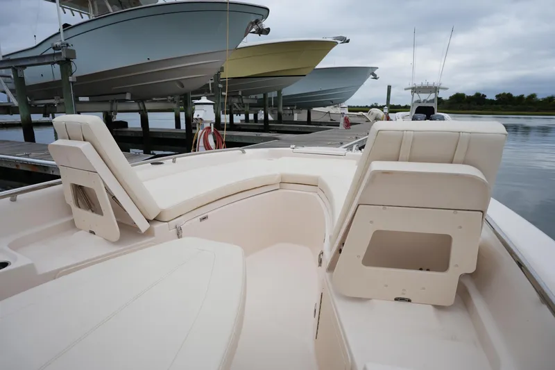 Slide: The Image of 2023 Grady-White 251 Coastal Explorer boat interior with docked vessels in background. - 41