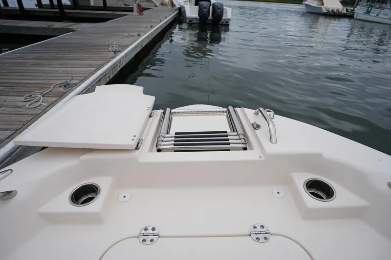 Slide: The Image of 2023 Grady-White 251 Coastal Explorer boat at dock with swim ladder. - 43
