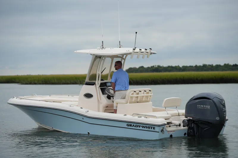 Slide: The Image of 2023 Grady-White 251 Coastal Explorer boat on calm water, featuring Yamaha engine. - 6