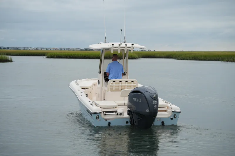 Slide: The Image of 2023 Grady-White 251 Coastal Explorer boat navigating calm waters. - 7