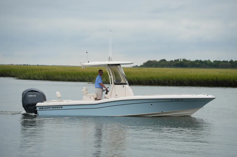 Slide: The Image of 2023 Grady-White 251 Coastal Explorer boat cruising on calm water. - 8