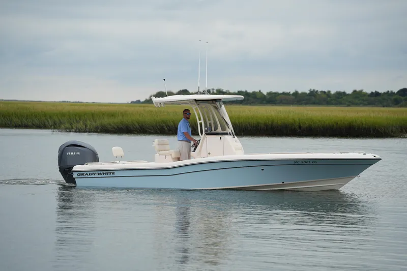 Slide: The Image of 2023 Grady-White 251 Coastal Explorer boat cruising on calm water. - 9