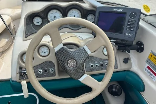 Slide: The Image of 2000 Glastron GX 180 dashboard with steering wheel and Lowrance HDS-7 navigation system. - 12
