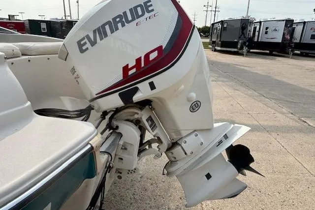 Slide: The Image of Evinrude E-TEC HO outboard motor on 2000 Glastron GX 180 boat, parked outdoors. - 3