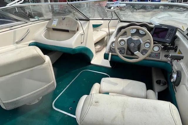 Slide: The Image of 2000 Glastron GX 180 boat interior with steering wheel and seating. - 8