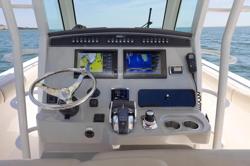 Slide: The Image of Control panel of 2016 Boston Whaler 330 Outrage with navigation screens and steering wheel. - 10