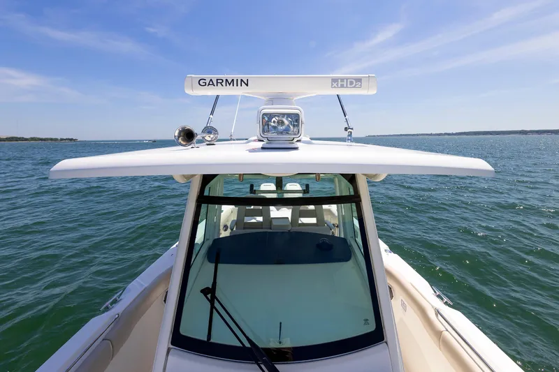 Slide: The Image of 2016 Boston Whaler 330 Outrage boat on open water, featuring Garmin radar. - 14