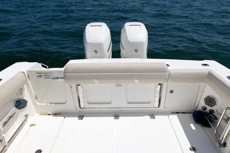 Slide: The Image of Boston Whaler 330 Outrage 2016 boat deck with twin engines on open water. - 18