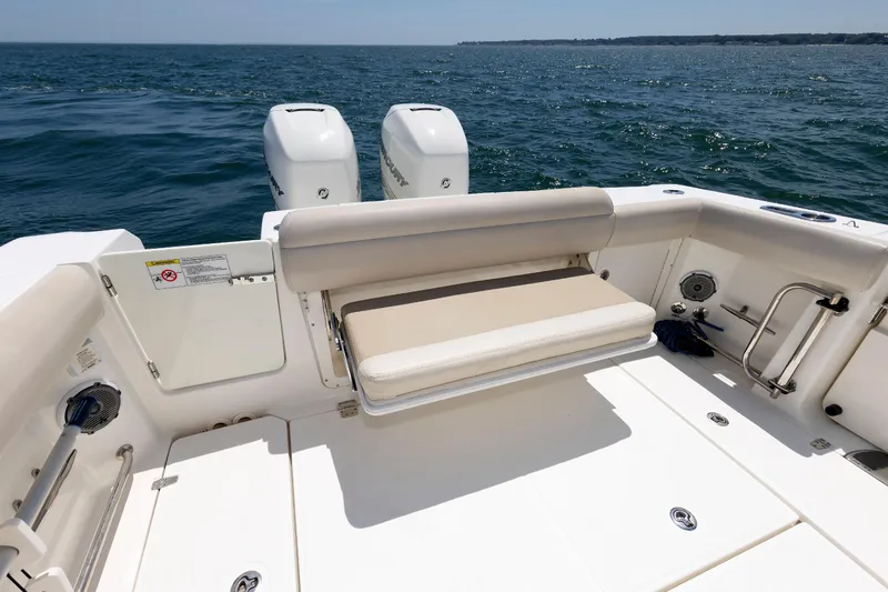 Slide: The Image of 2016 Boston Whaler 330 Outrage boat with dual engines and seating, on open water. - 21
