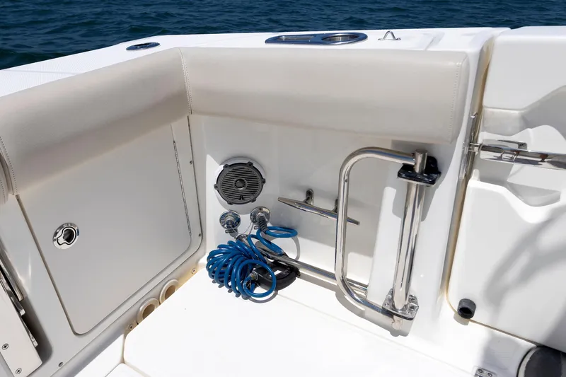 Slide: The Image of Boston Whaler 330 Outrage 2016 boat interior with coiled hose and speaker. - 22