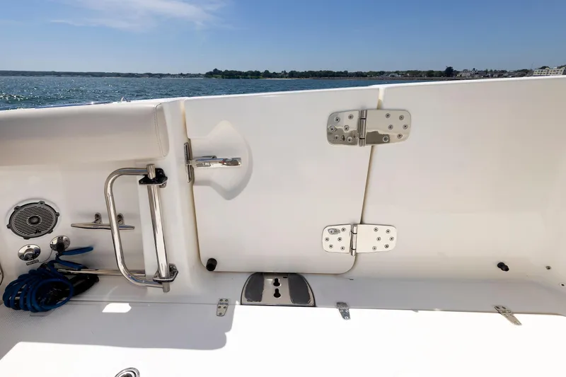 Slide: The Image of 2016 Boston Whaler 330 Outrage boat deck with ocean view, featuring stainless steel fittings. - 23