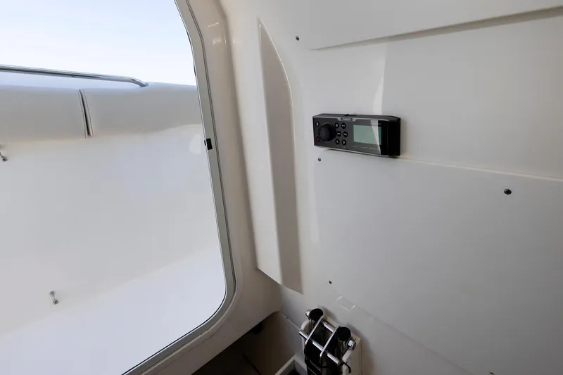Slide: The Image of Interior view of a 2016 Boston Whaler 330 Outrage boat, featuring a mounted control panel. - 25