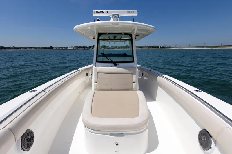 Slide: The Image of 2016 Boston Whaler 330 Outrage boat on water, featuring spacious seating and Garmin equipment. - 3