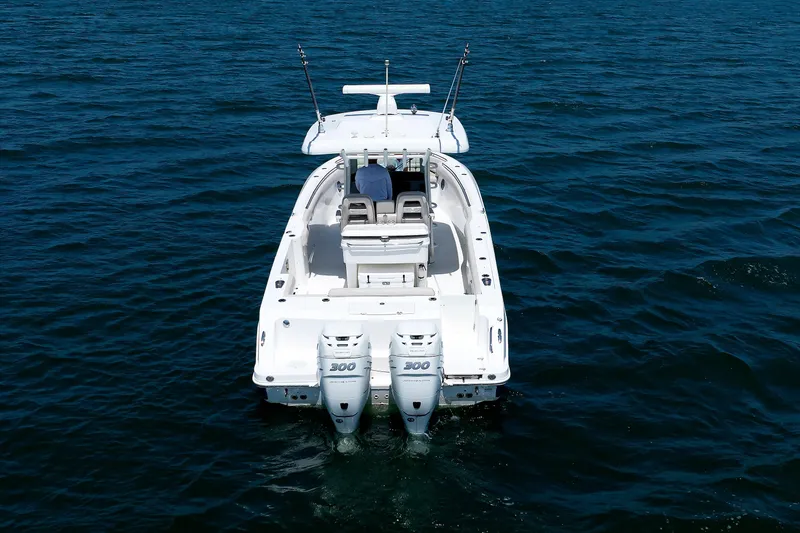 Slide: The Image of 2016 Boston Whaler 330 Outrage boat on open water, rear view. - 32